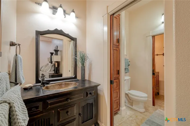 a spacious bedroom with a bed and a chandelier