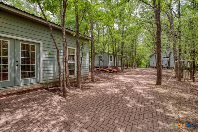 a view of a room with wooden floor and windows