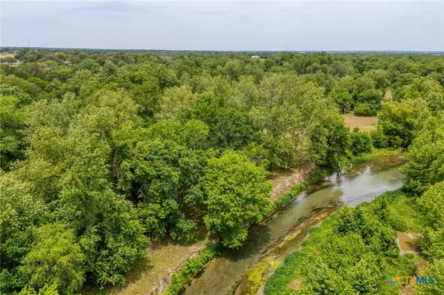 an aerial view of a house with yard