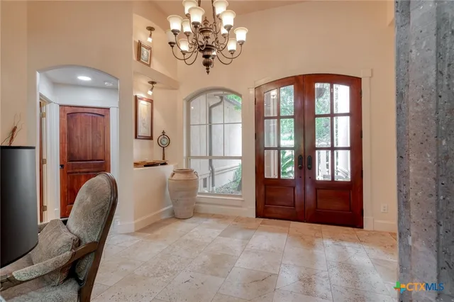 a view of a livingroom with furniture cabinet and a chandelier