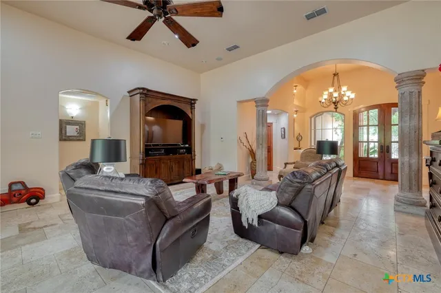 a living room with furniture and a large mirror