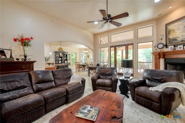 a living room with furniture ceiling fan and a fireplace