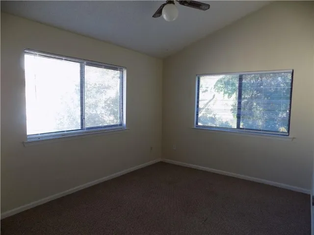 a view of an empty room with windows