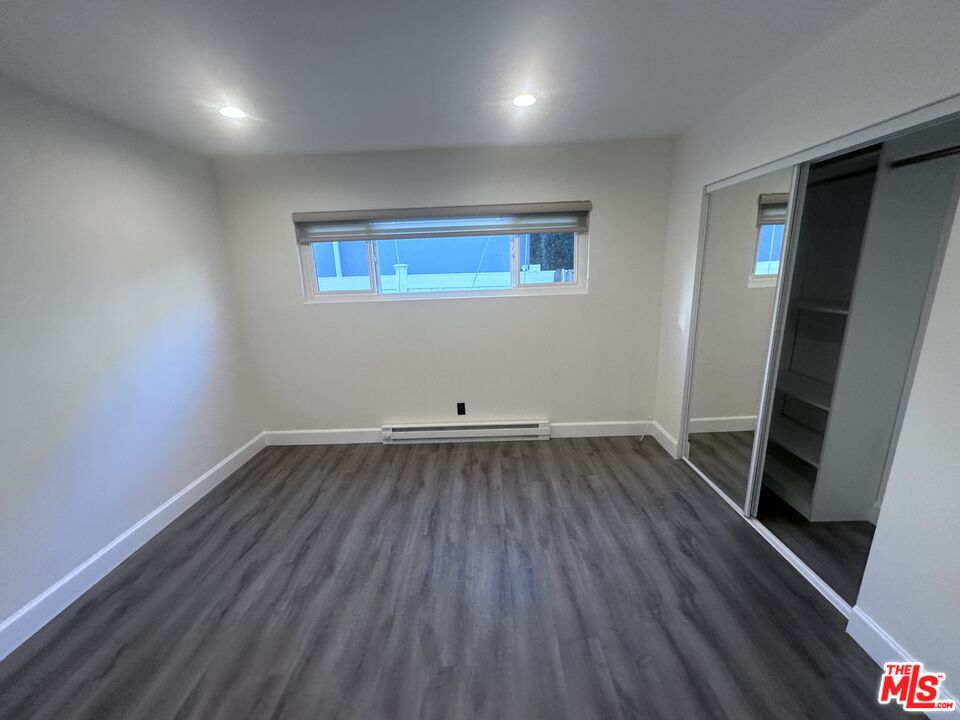 2228 20th Street, Unit 2 Santa Monica, CA 90405 - Photo 12 of 43 an empty room with wooden floor and windows