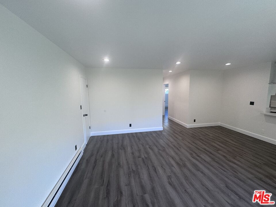 2228 20th Street, Unit 2 Santa Monica, CA 90405 - Photo 2 of 43 a view of a room with wooden floor and bench