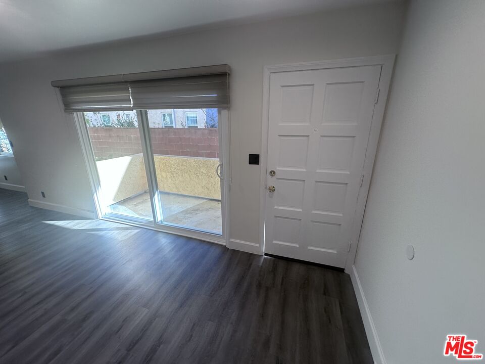 2228 20th Street, Unit 2 Santa Monica, CA 90405 - Photo 21 of 43 an empty room with wooden floor and windows