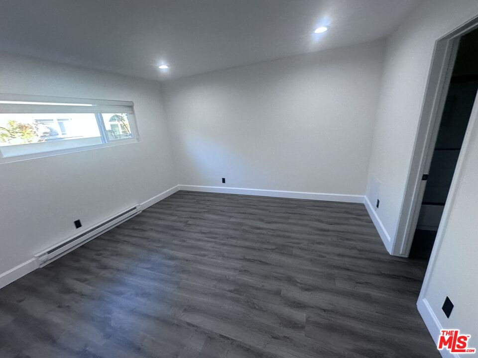 2228 20th Street, Unit 2 Santa Monica, CA 90405 - Photo 33 of 43 an empty room with wooden floor and windows