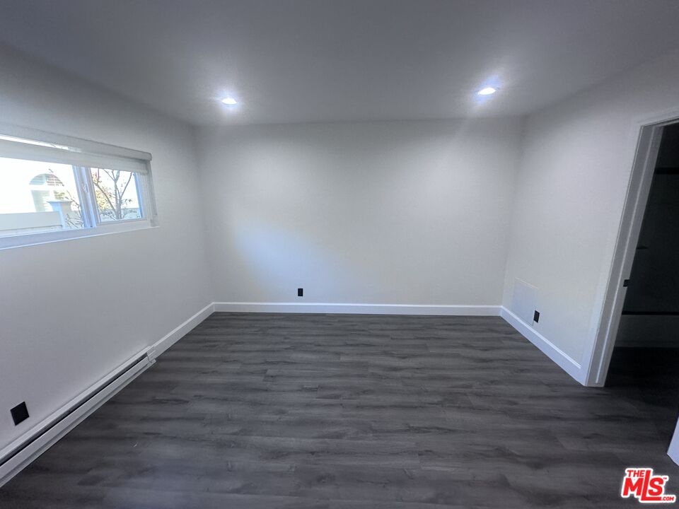 2228 20th Street, Unit 2 Santa Monica, CA 90405 - Photo 34 of 43 a view of a room with wooden floor and window