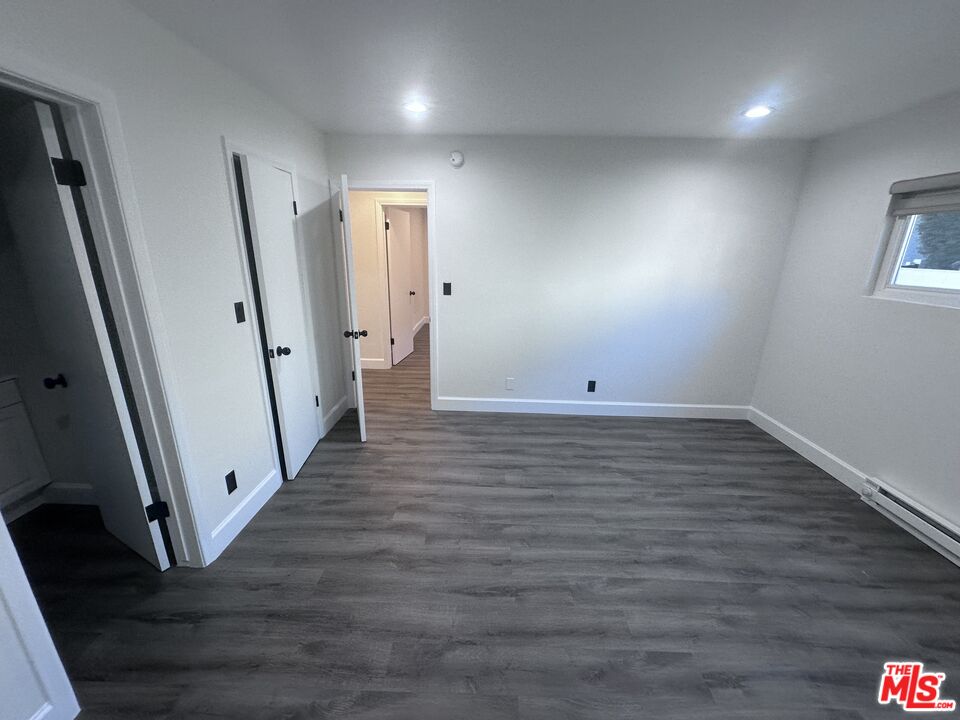 2228 20th Street, Unit 2 Santa Monica, CA 90405 - Photo 38 of 43 an empty room with wooden floor and staircase