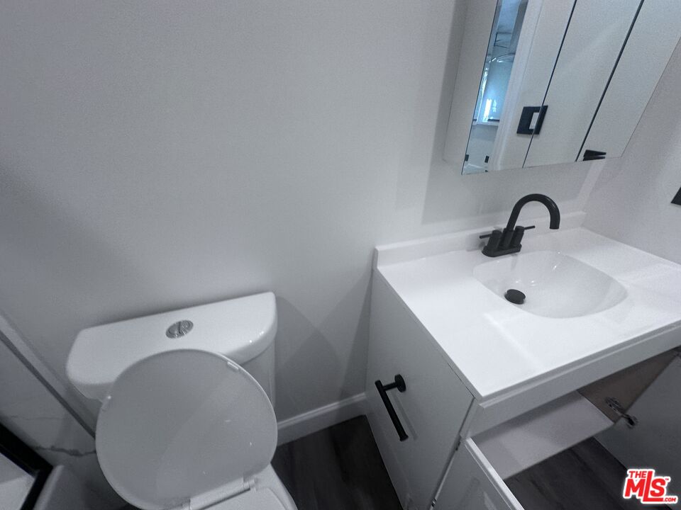 2228 20th Street, Unit 2 Santa Monica, CA 90405 - Photo 42 of 43 a bathroom with a sink mirror and toilet