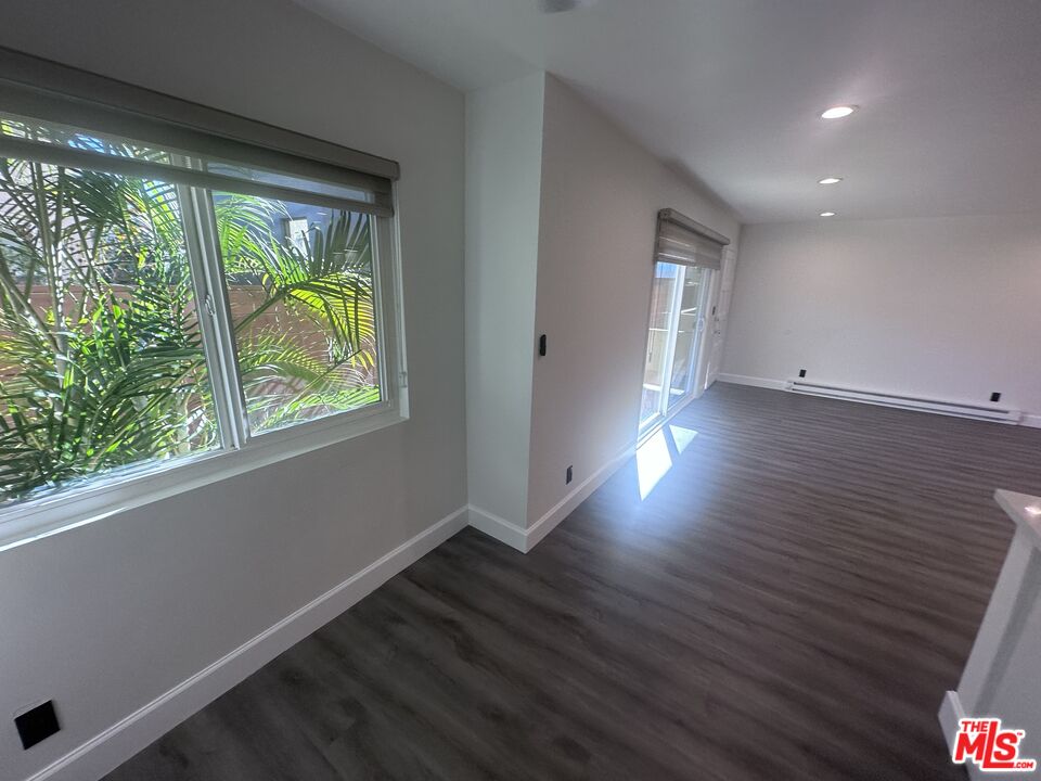 2228 20th Street, Unit 2 Santa Monica, CA 90405 - Photo 6 of 43 an empty room with wooden floor and windows