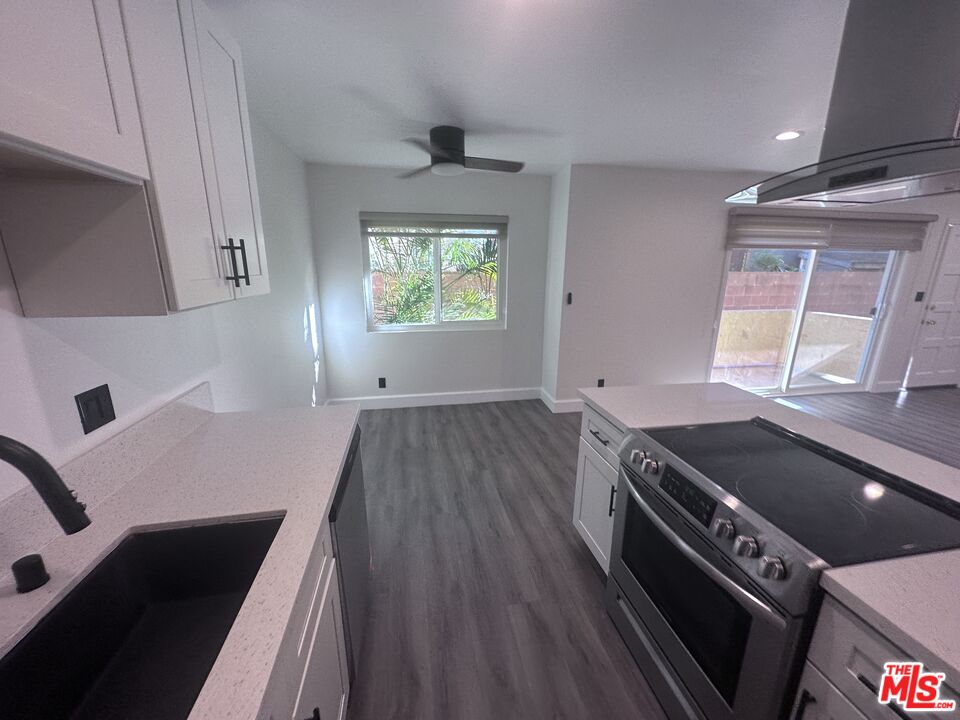 2228 20th Street, Unit 2 Santa Monica, CA 90405 - Photo 7 of 43 a kitchen with wooden floors and a stove