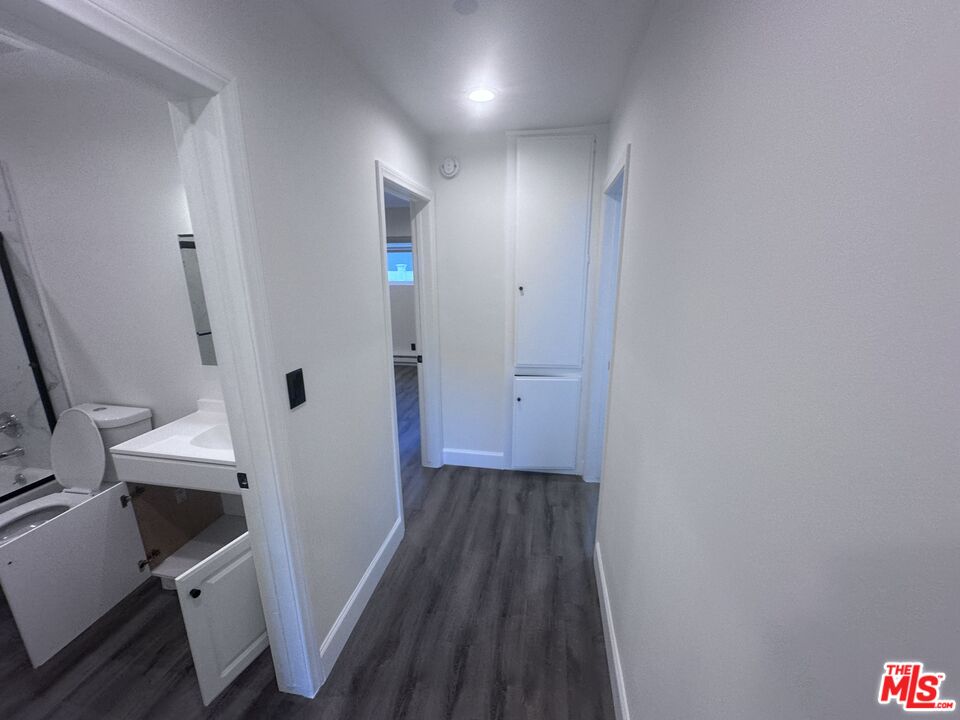 2228 20th Street, Unit 2 Santa Monica, CA 90405 - Photo 8 of 43 a view of a hallway with wooden floor and a bathroom