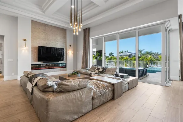 a living room with furniture and a chandelier