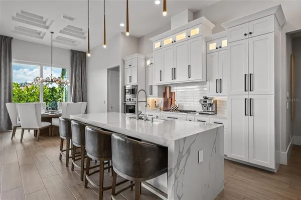 a kitchen with white cabinets stainless steel appliances and sink