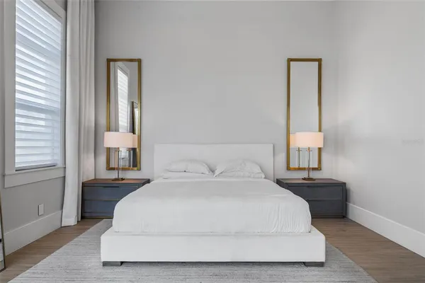 a bedroom with a bed and a book shelf