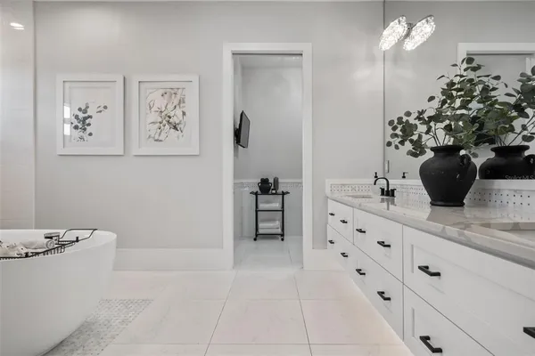 a bathroom with a granite countertop toilet a sink and a mirror