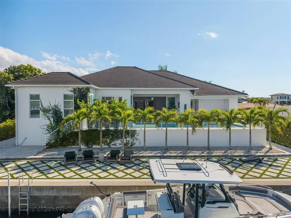 a view of a lobby with a chair and potted plants