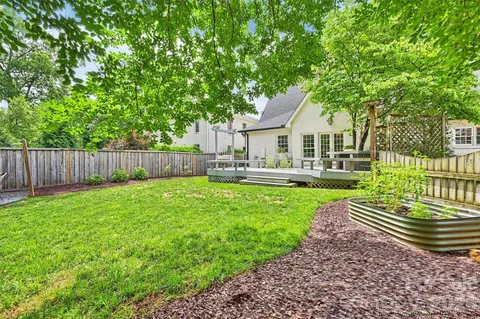 a house view with swimming pool and garden space