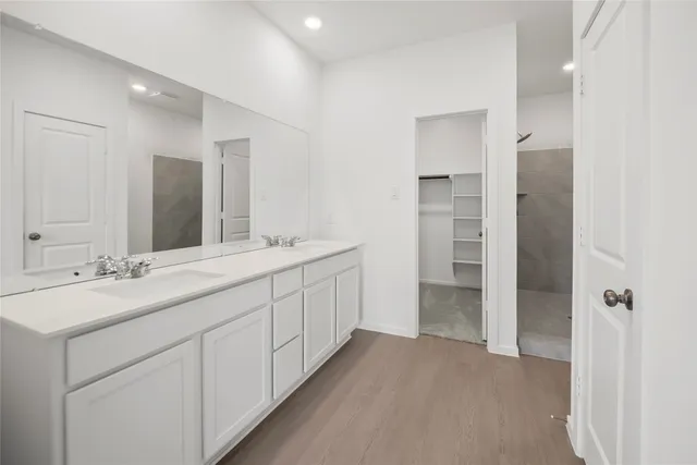 a bathroom with a double vanity sink and a mirror