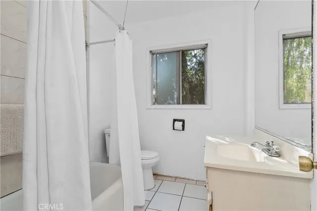 a bathroom with a sink toilet and mirror