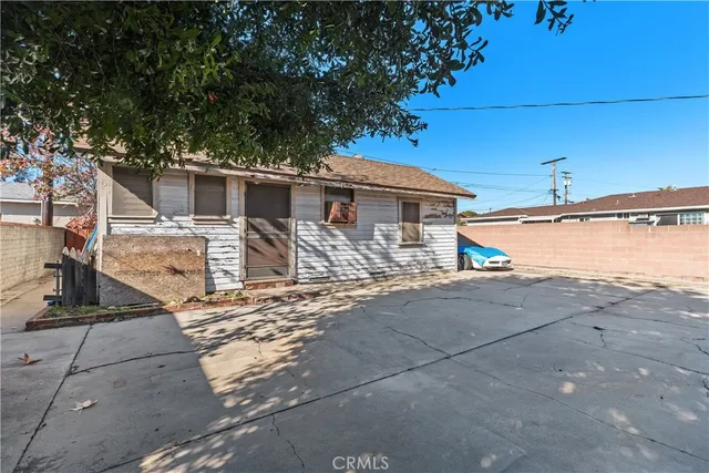 a view of a patio with table and chairs under an umbrella