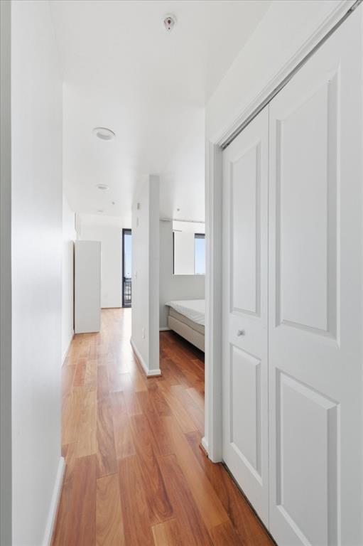 a view of a hallway with wooden floor