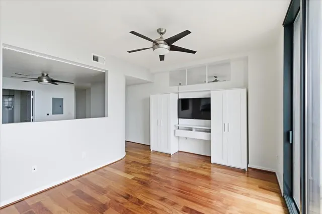 a living room with stainless steel appliances kitchen island furniture and wooden floor