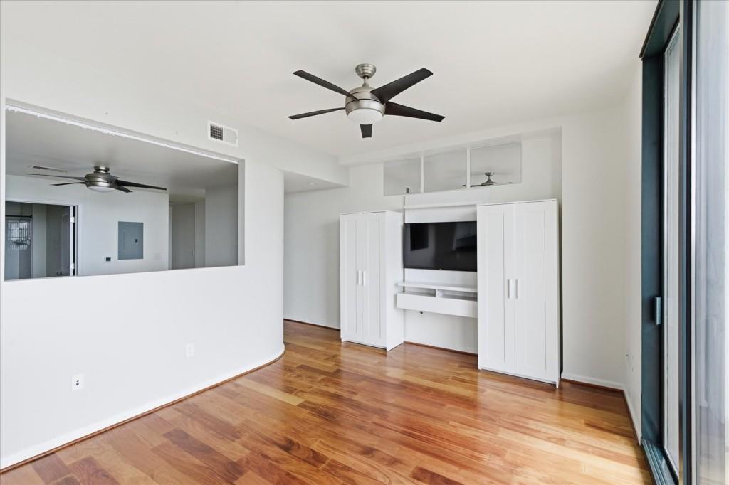 3040 Peachtree Road Northwest, Unit 805 Atlanta, GA 30305 - Photo 11 of 36 a living room with stainless steel appliances kitchen island furniture and wooden floor