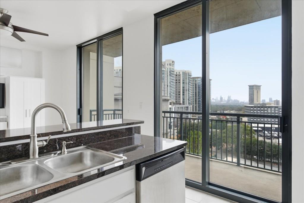 3040 Peachtree Road Northwest, Unit 805 Atlanta, GA 30305 - Photo 15 of 36 a kitchen with a sink and a window