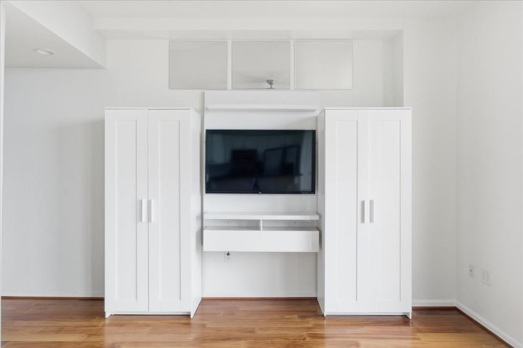 3040 Peachtree Road Northwest, Unit 805 Atlanta, GA 30305 - Photo 20 of 36 a view of an empty room with wooden floor and a window