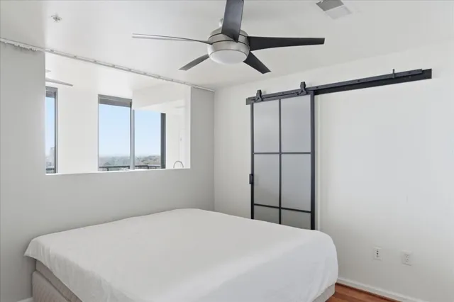 a bedroom with a bed and a window