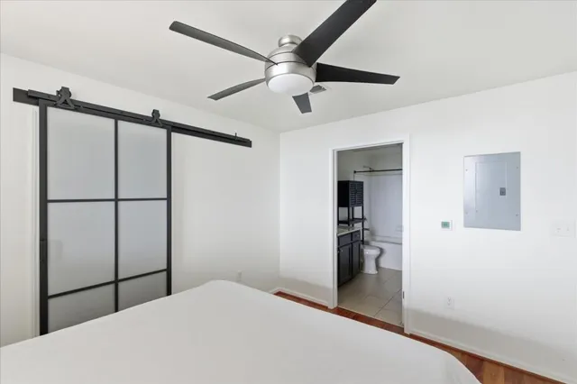 a bedroom with a bed and a chandelier