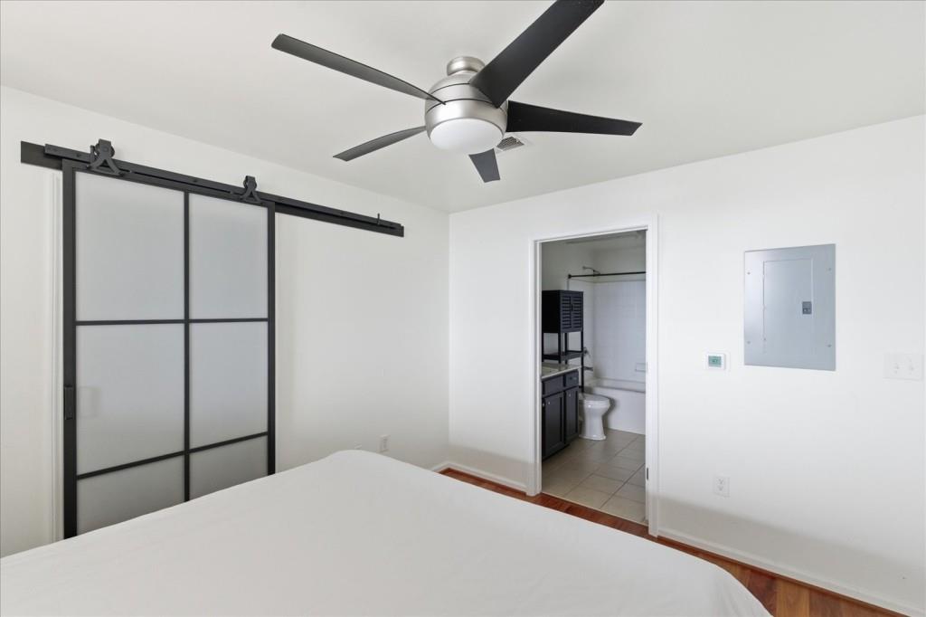 3040 Peachtree Road Northwest, Unit 805 Atlanta, GA 30305 - Photo 4 of 36 a bedroom with a bed and a chandelier