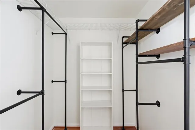 a view of a hallway with closet and window