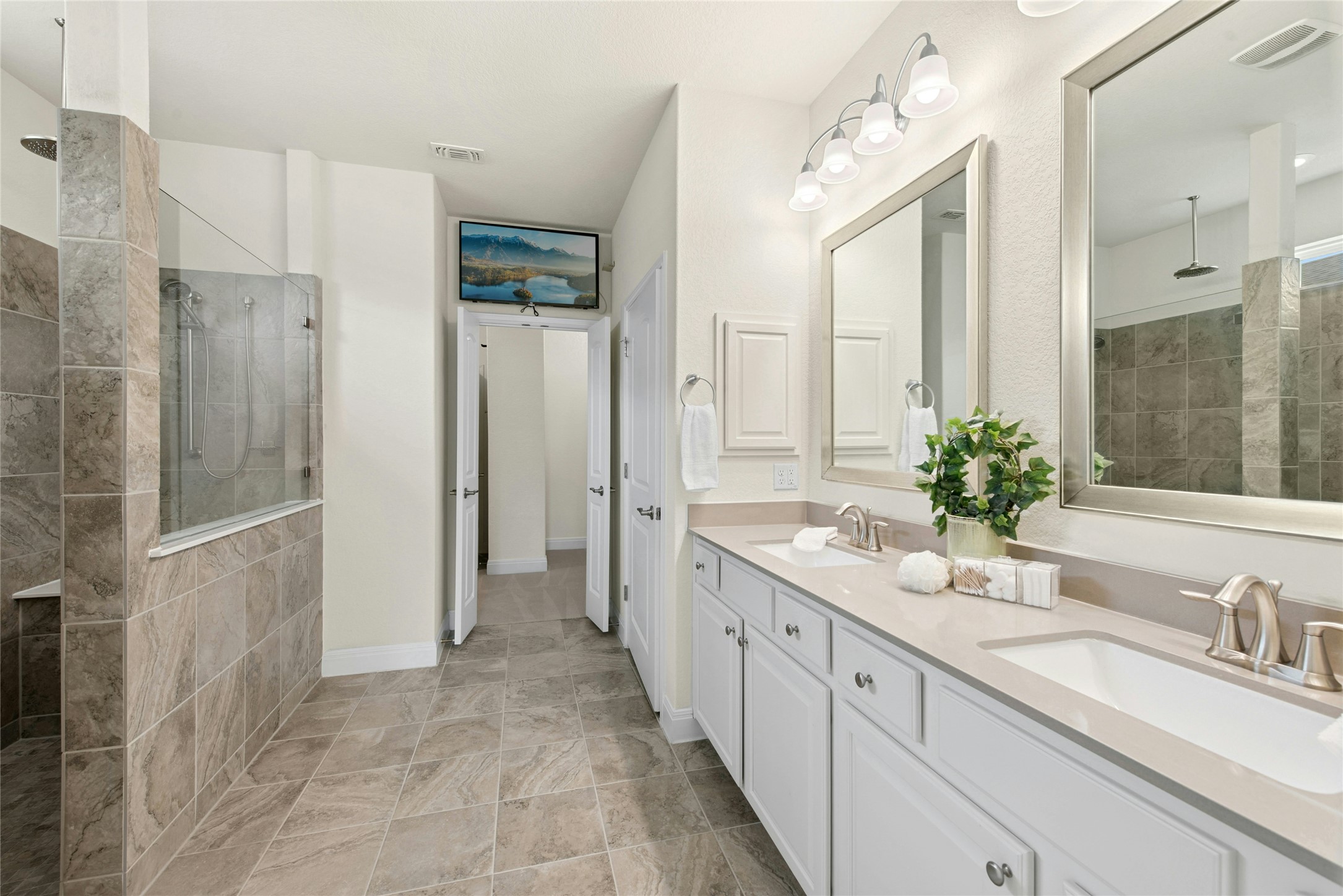 105 Marfa Cove Georgetown, TX 78633 - Photo 19 of 36 a spacious bathroom with double vanity a mirror and shower