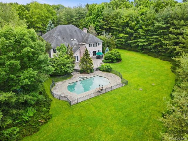 a aerial view of a house with swimming pool and garden