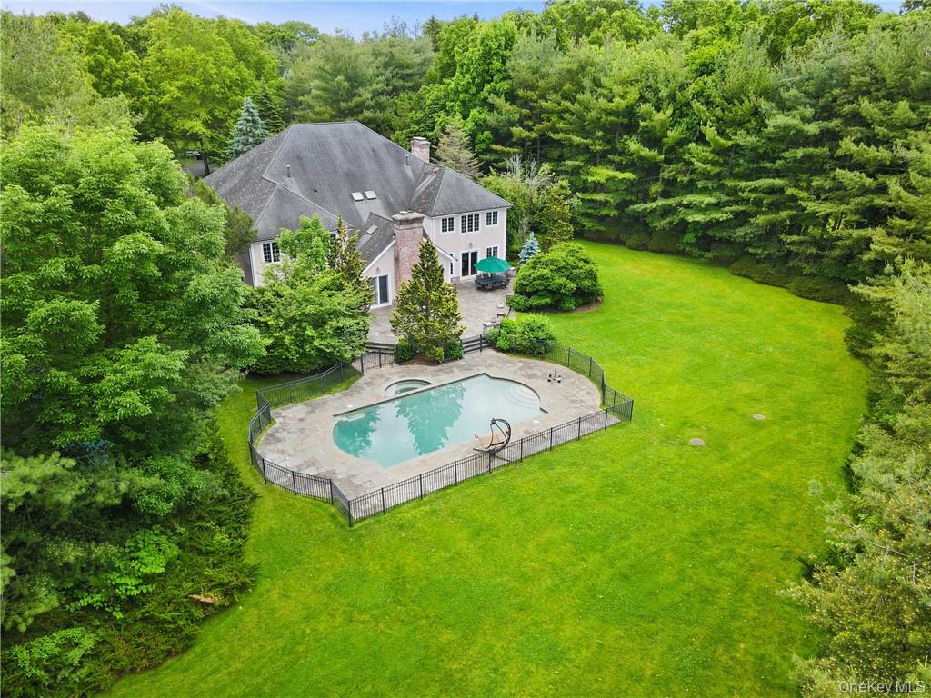 a aerial view of a house with swimming pool and garden