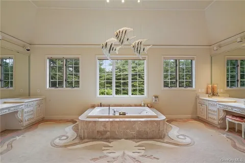 a spacious bathroom with bathtub and window