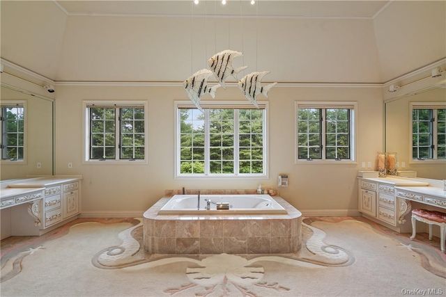 a spacious bathroom with bathtub and window