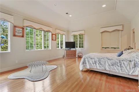 a bedroom with a bed and glass window