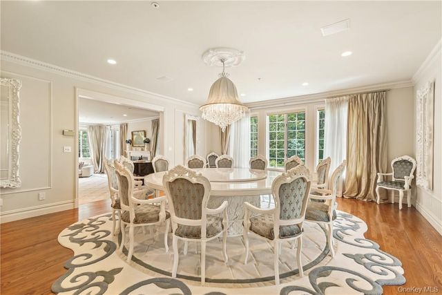 a view of a dining room with furniture wooden floor and chandelier