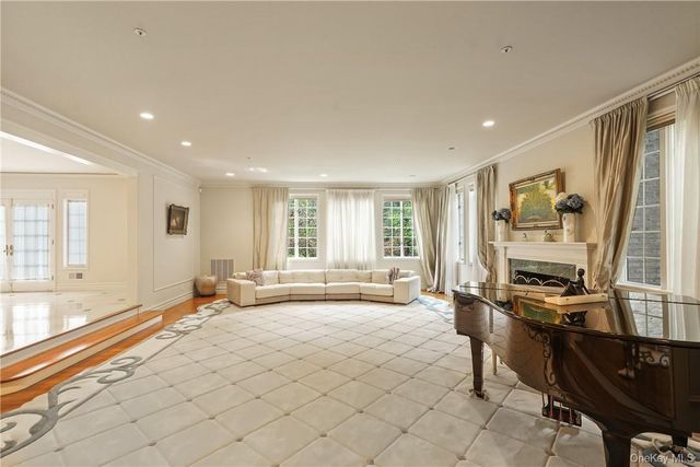 a spacious bedroom with a bed and a large window