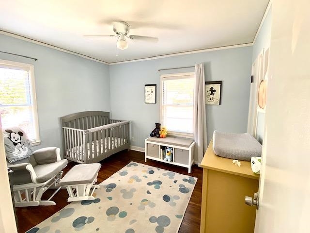 4787 Flamingo Road Memphis, TN 38117 - Photo 10 of 18 a bedroom with a bed and wooden floor