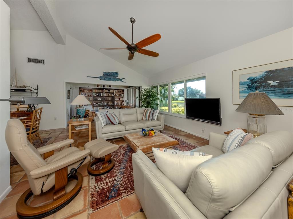 786 Sarabay Road, Unit 19 Osprey, FL 34229 - Photo 20 of 60 a living room with furniture and a flat screen tv