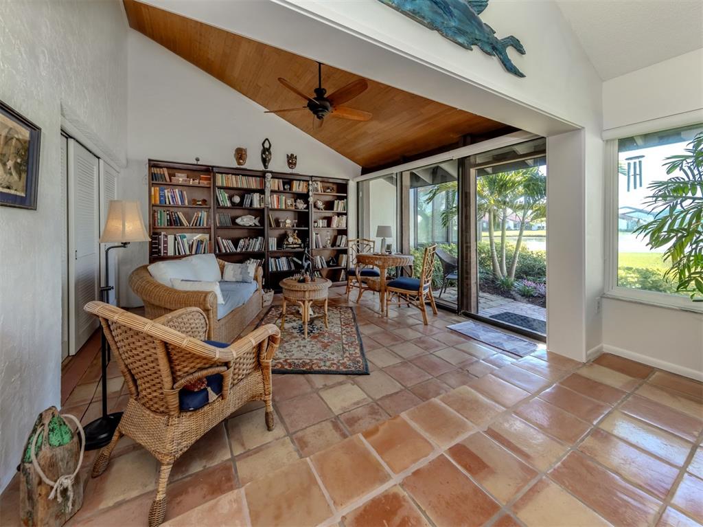 786 Sarabay Road, Unit 19 Osprey, FL 34229 - Photo 23 of 60 a dining room with furniture and a floor to ceiling window