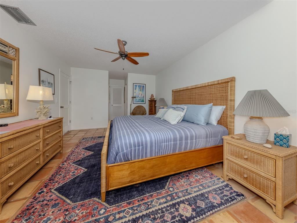 786 Sarabay Road, Unit 19 Osprey, FL 34229 - Photo 27 of 60 a bedroom with a bed and dresser