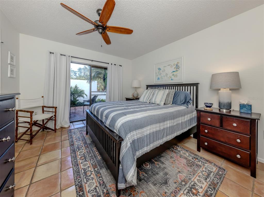 786 Sarabay Road, Unit 19 Osprey, FL 34229 - Photo 29 of 60 a bedroom with a bed and a chandelier