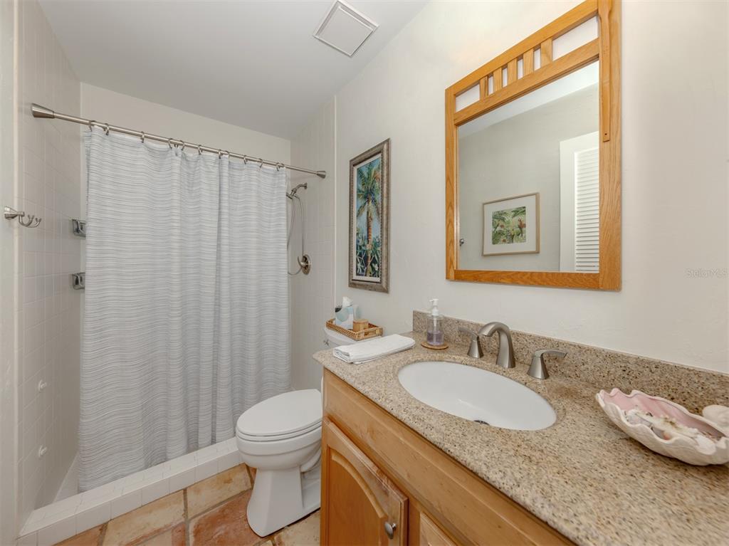 786 Sarabay Road, Unit 19 Osprey, FL 34229 - Photo 31 of 60 a bathroom with a granite countertop sink toilet and shower