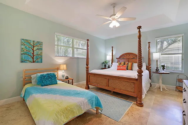 a bedroom with a bed and a painting on the wall